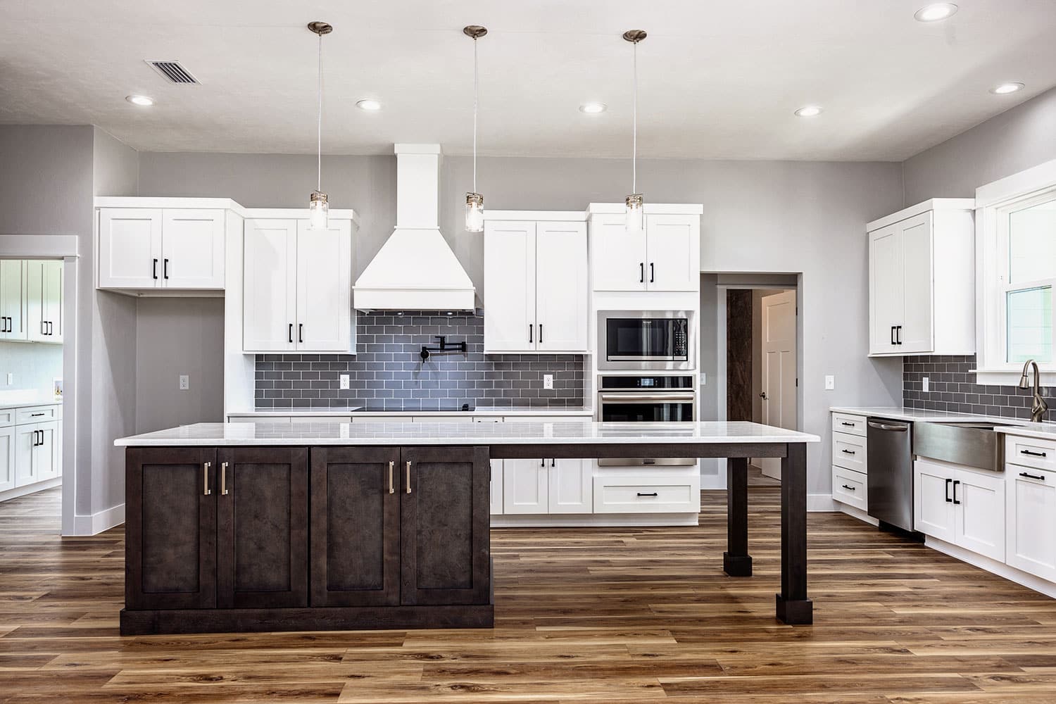 Kitchen remodel countertop replacement in High Springs, FL with island, updated surfaces, cabinetry, and bright lighting