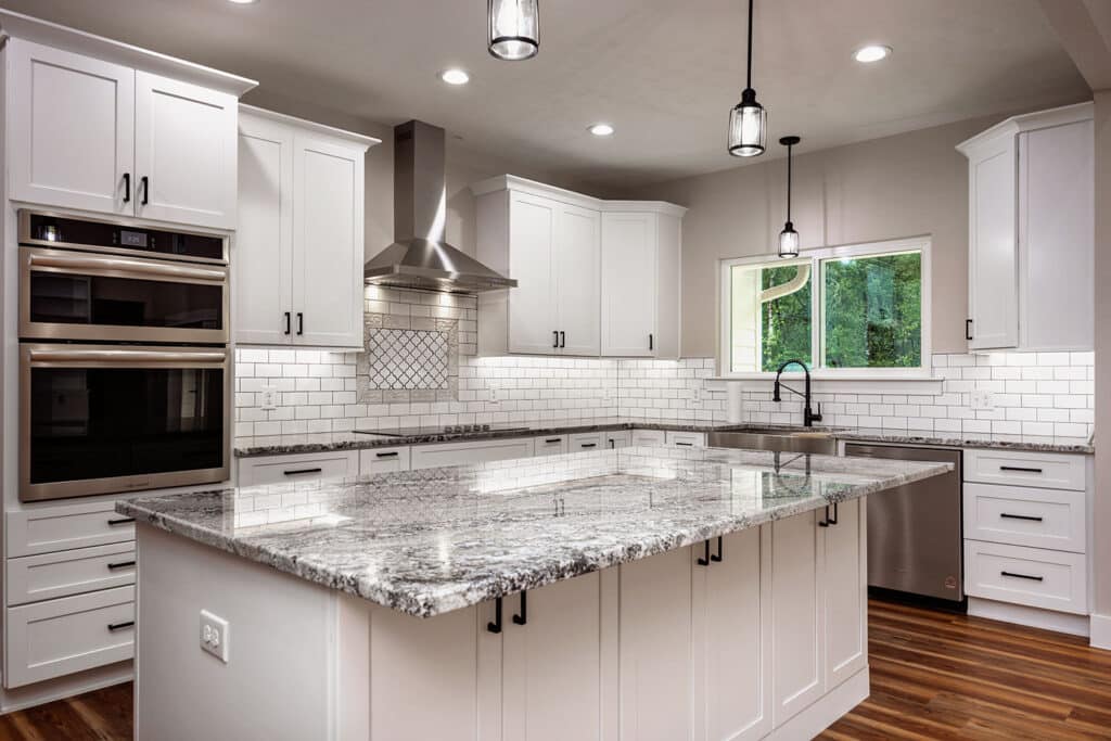 Kitchen remodeling services in High Springs, FL with updated island, countertops, cabinetry, tile backsplash, and lighting